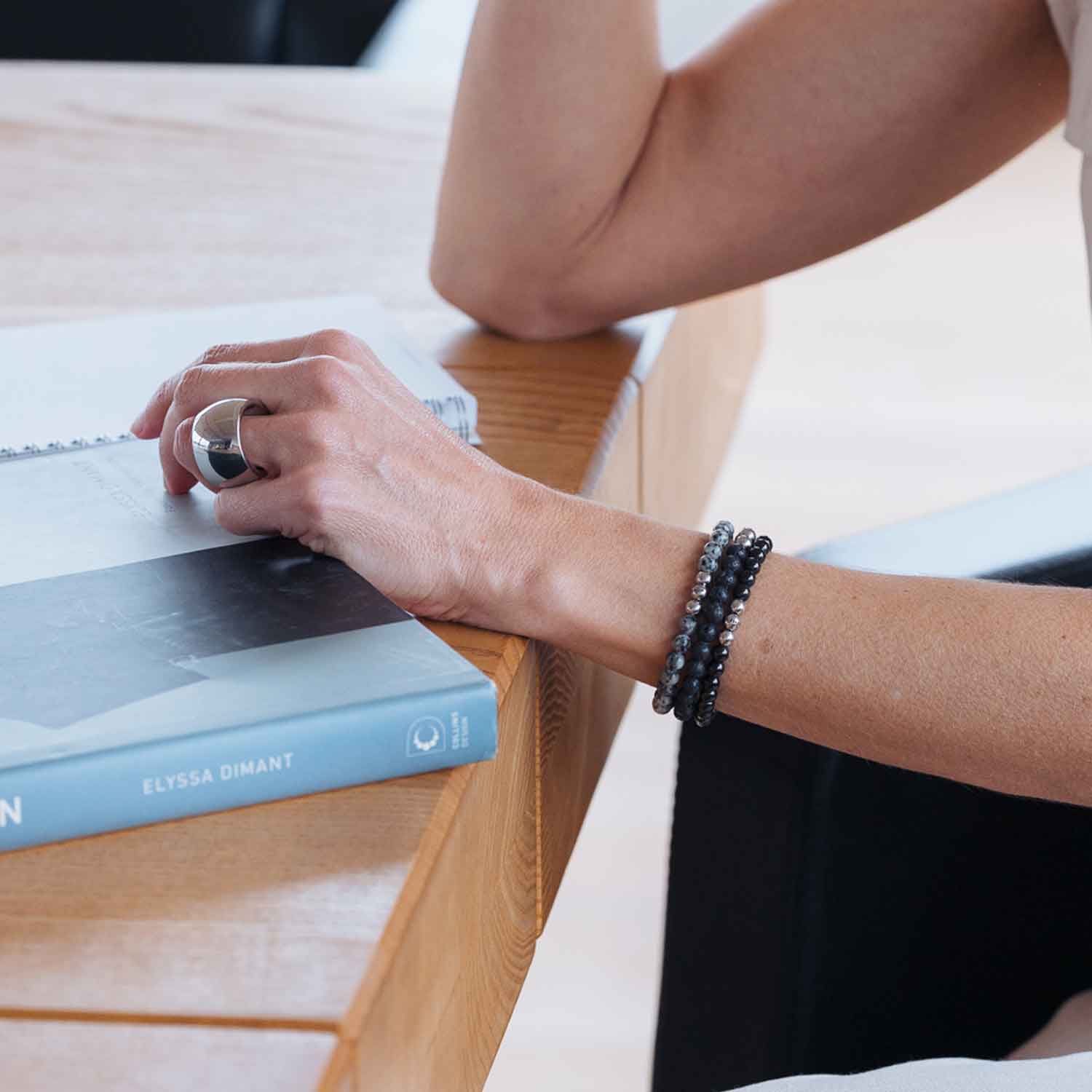 Gesamtansicht eines schwarzen Perlenarmbandes aus echten Onyxperlen mit drei antiallergenen Edelstahlperlen.