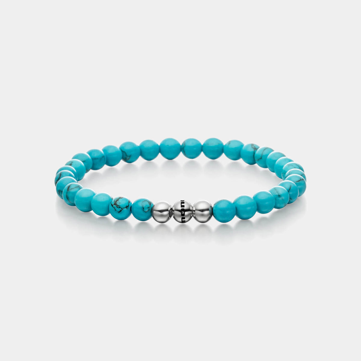 Gesamtansicht eines Perlenarmbandes aus echten Türkis-Perlen mit drei antiallergenen Edelstahlperlen.