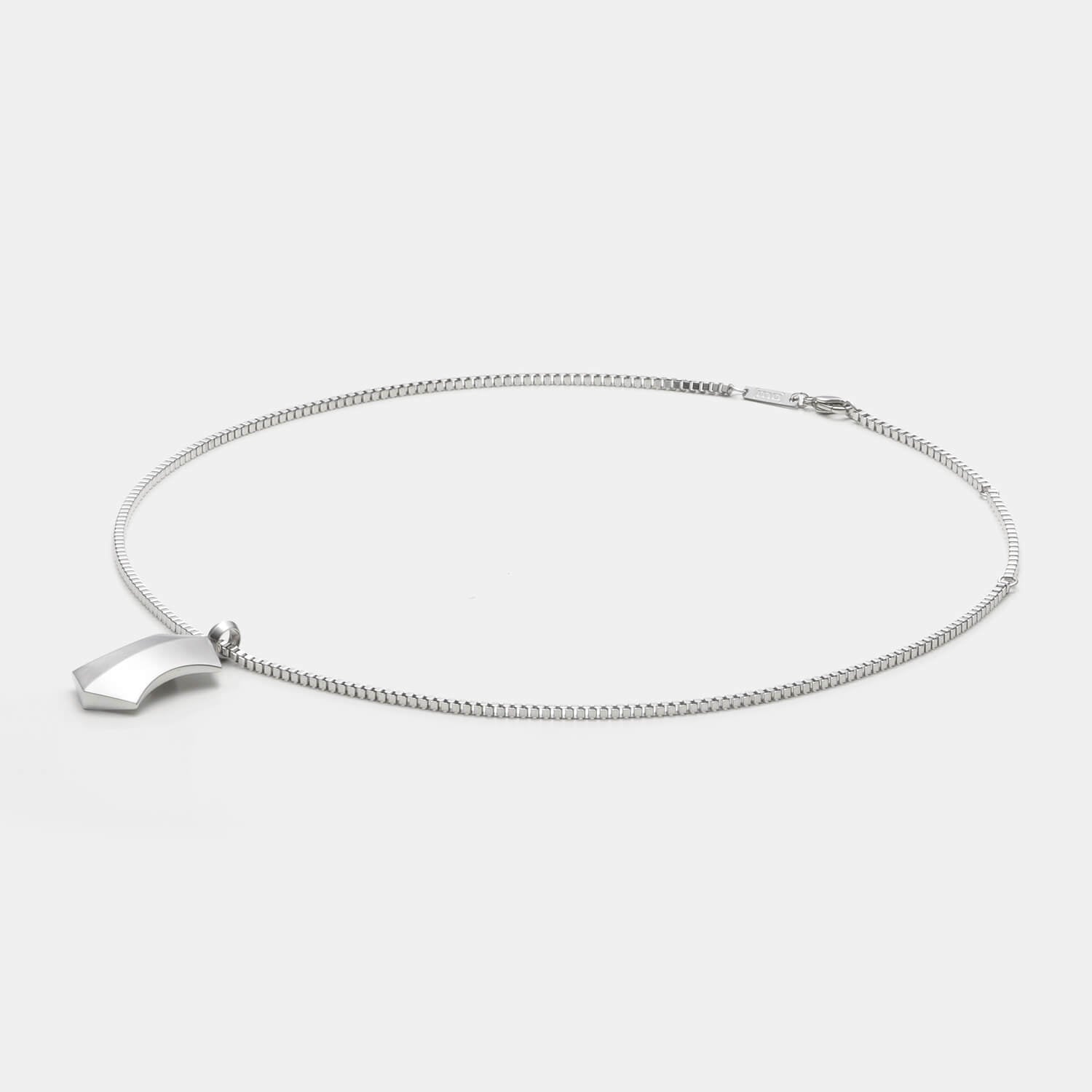 Detailansicht eines silberfarbenen, großen Kettenanhängers in Trapezform aus antiallergenem Edelstahl an einer Veneziakette.