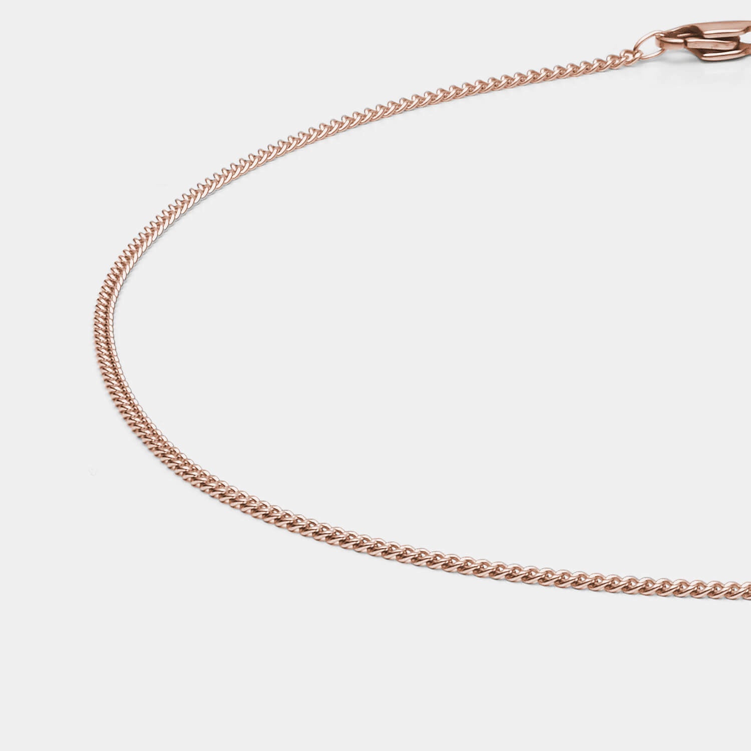 Zeitlose, diamantierte Panzerkette aus antiallergenem Edelstahl mit roségoldfarbener PVD-Beschichtung und Karabinerverschluss von MONOMANIA in Gesamtansicht.