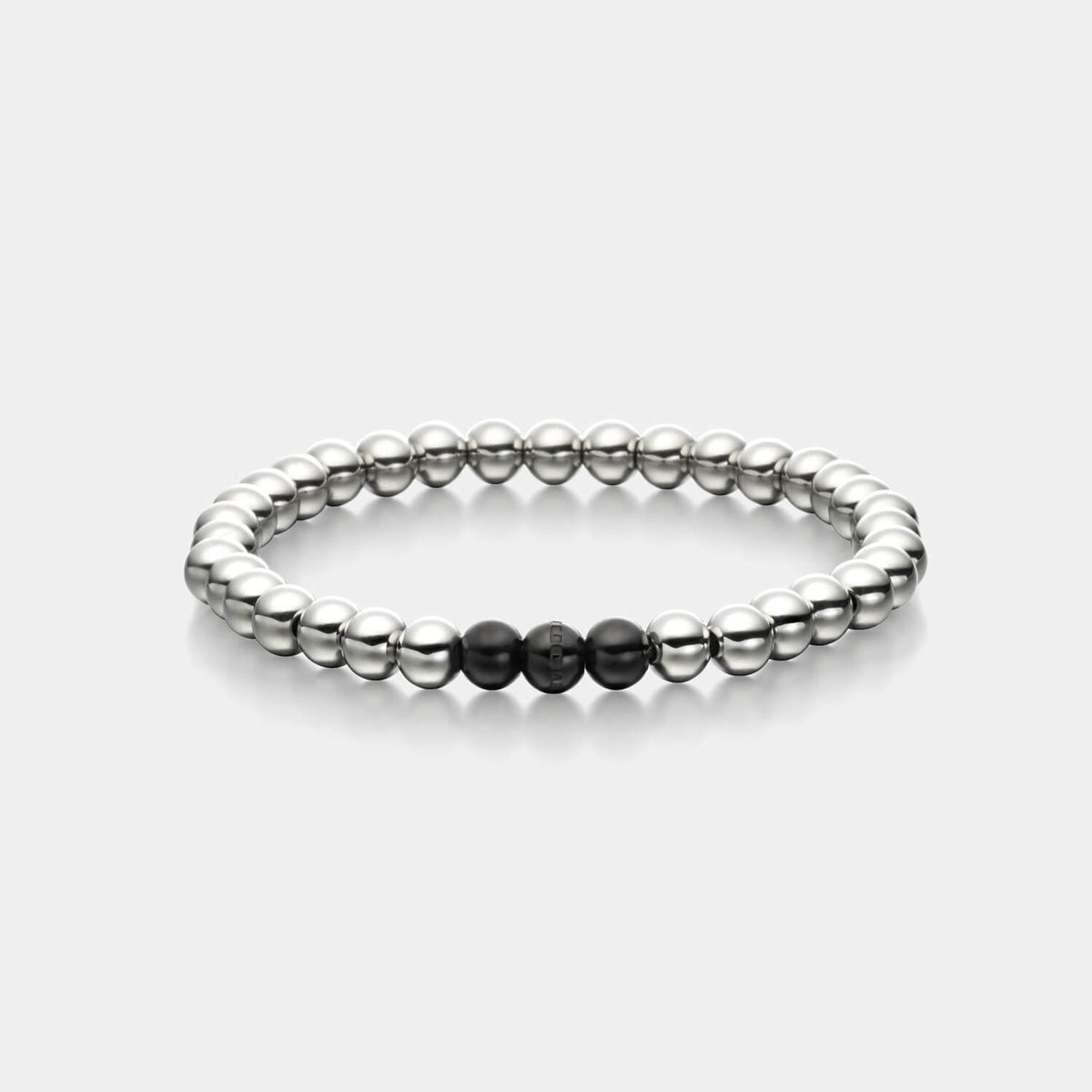 Gesamtansicht eines silberfarbenen Perlenarmbandes mit drei schwarz-beschichteten, antiallergenen Edelstahl-Perlen.